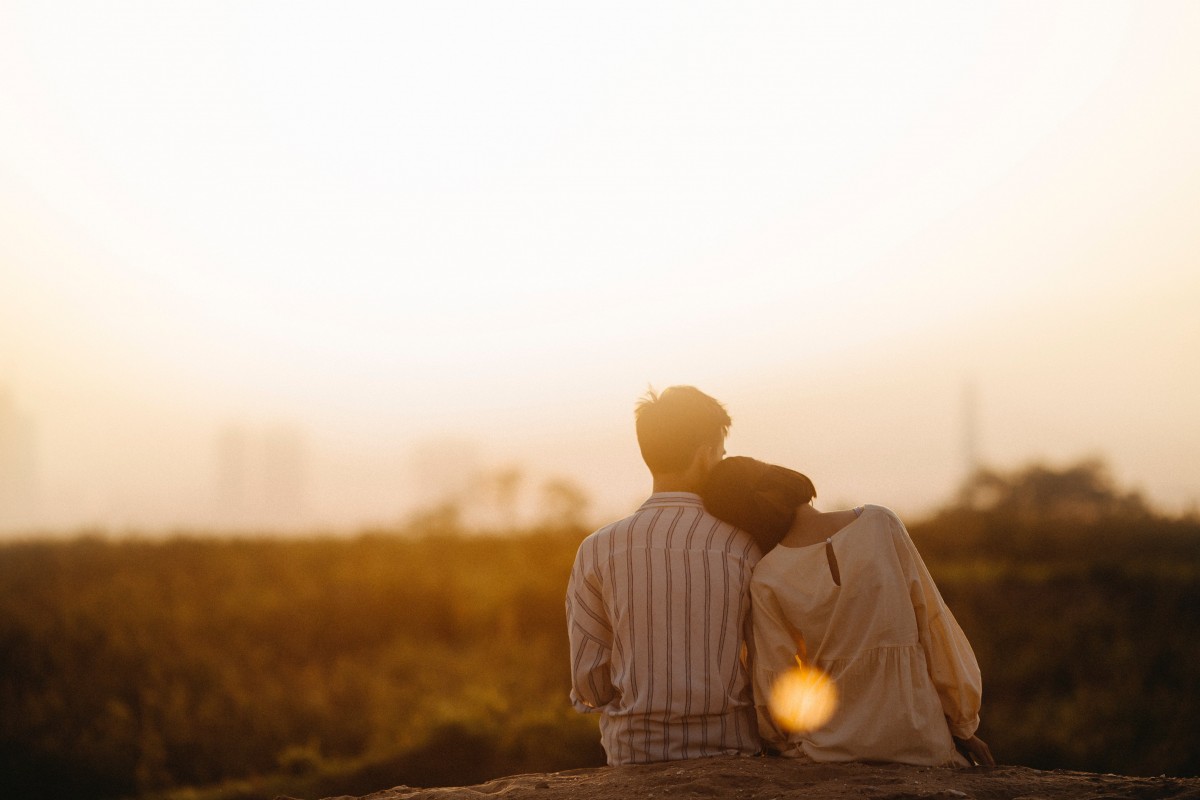 Man and woman watching a sunset together