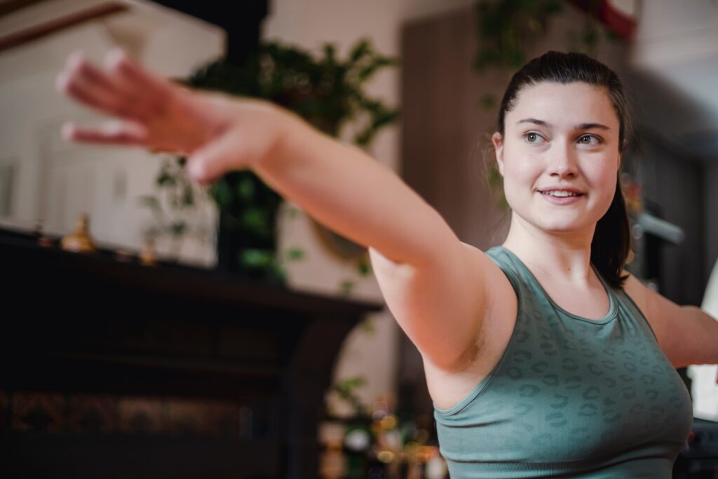 woman stretching arms out in yoga pose with ease