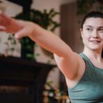 woman stretching arms out in yoga pose with ease