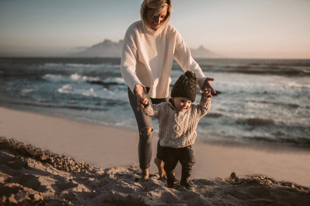 Mother and Her Child Walking on the Shore
