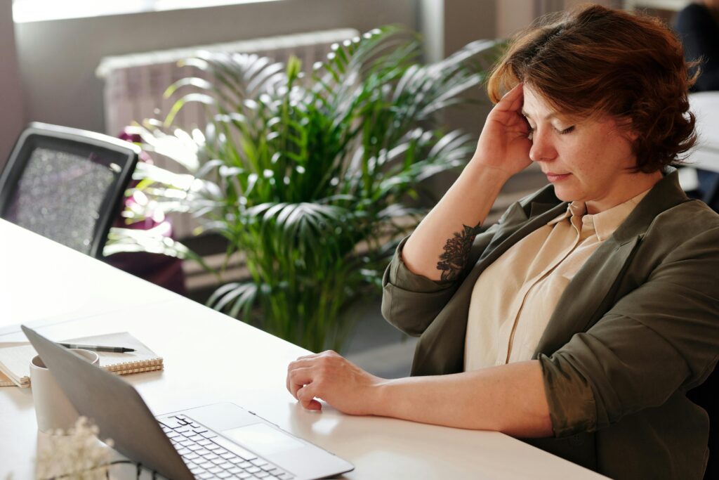 woman holding side of her head in pain from tmj