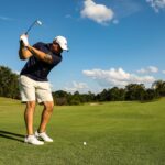 man mid-swing playing golf